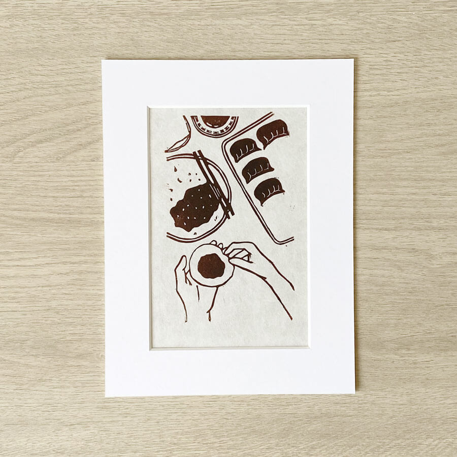 Wrapping dumplings Linocut