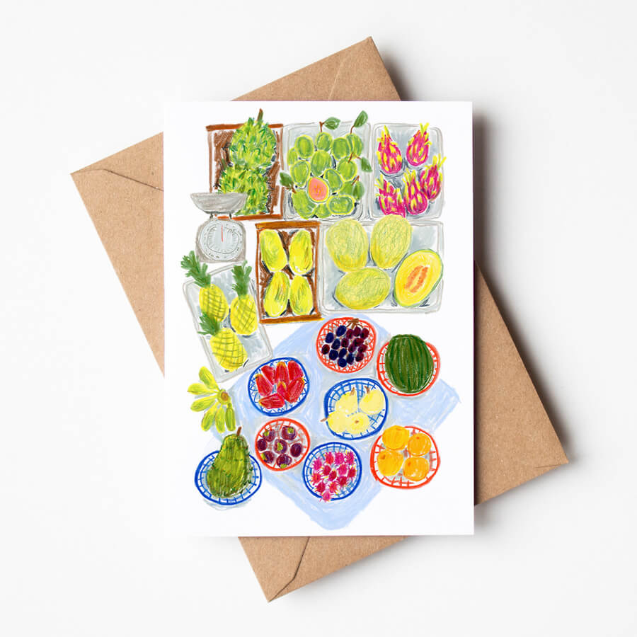A illustrated greeting card featuring a playful scene of a South East Asian fruit market printed on eco friendly and sustainable materials