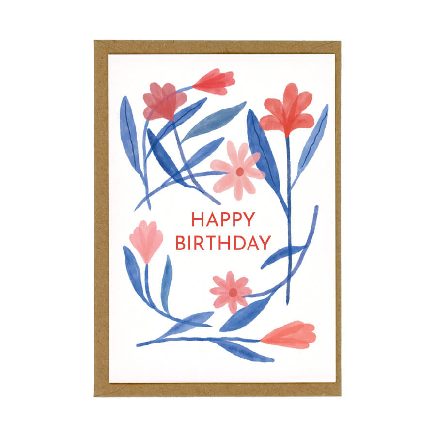 A happy birthday greeting card featuring illustrated red and blue flowers made with eco-friendly materials