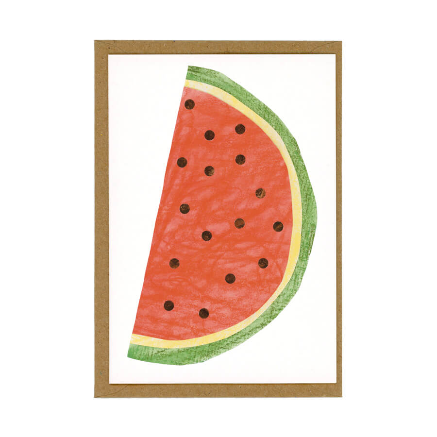 An illustrated card of a watermelon slice made from eco friendly materials displayed on a brown paper envelope