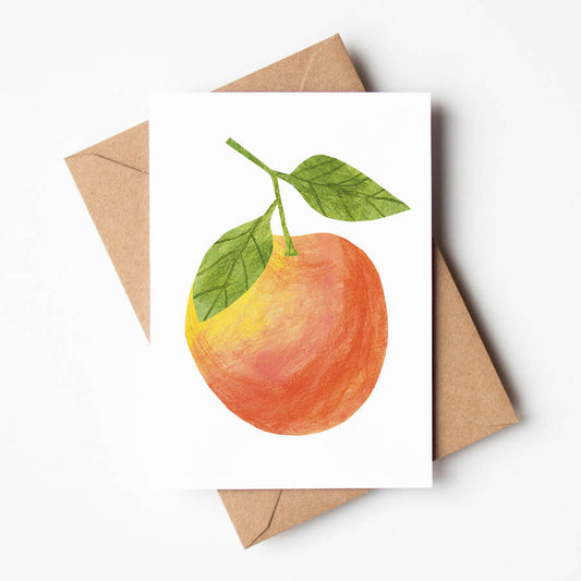 A card featuring the digital reproduction of a papercut apple on a white background. The eco friendly card is displayed atop a brown recycled envelope